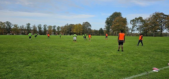 Players wearing training bibs during a UAA football session on The Racecourse